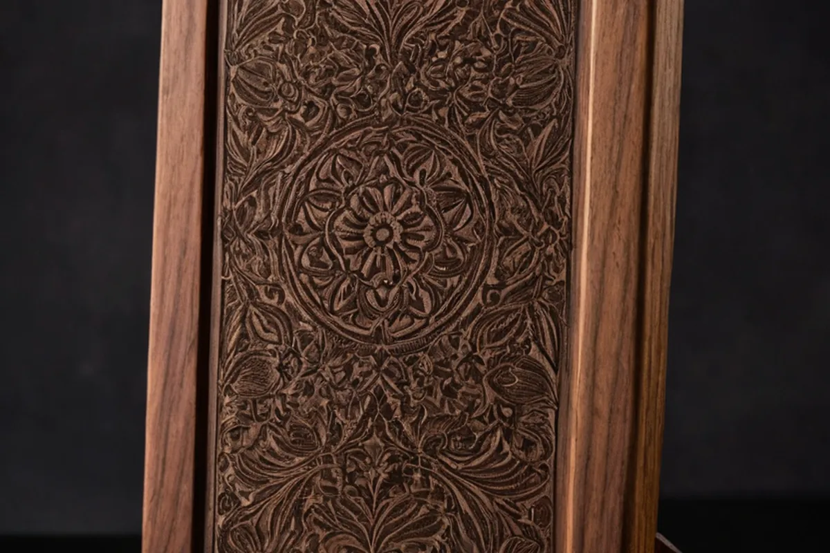A laser-engraved walnut panel with deep, crisp detail